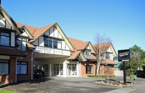 a building with a sign in front of it at Champers Motor Inn in Lower Hutt