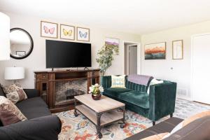 a living room with a couch and a tv at King & Queen First Floor Unit! 1-2c Georgetown Villas in Fairview Park