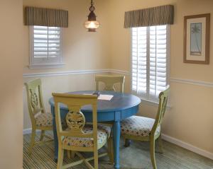 a dining room with a blue table and chairs at Club Wyndham Beach Street Cottages in Destin +8 photos