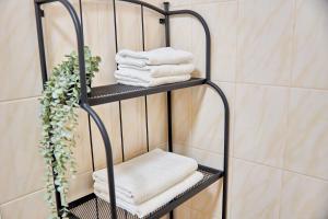 a towel rack with towels on it in a bathroom at Best Apartments on Kyryla & Mefodia in Mukacheve +161 photos