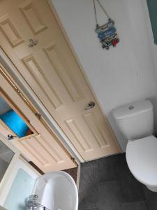 a bathroom with a toilet and a sink at H9 Fairway Holiday Park Sandown in Sandown