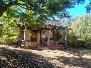 a stone house with a table in front of it at Casas el Alamillo- el Castañero in Galaroza