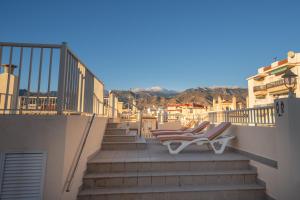 a pair of lounge chairs sitting on a balcony at Apartamentos Solset Nerja in Nerja
