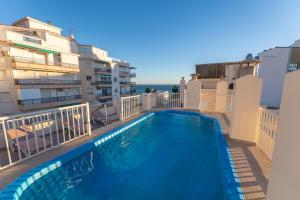 a swimming pool on the balcony of a building at Apartamentos Solset Nerja in Nerja