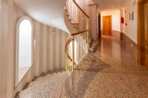 a hallway with a spiral staircase in a house at Apartamentos Solset Nerja in Nerja
