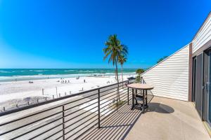 a balcony with a table and a beach at Fanta-Sea 55 in Siesta Key