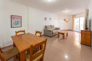 a living room with a table and a couch at Apartamentos Solset Nerja in Nerja