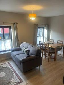 a living room with a couch and a table at The Drapery in Ferbane