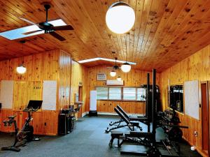 a gym with wood paneling and exercise equipment in it at NewVida Preserve in Wilmington