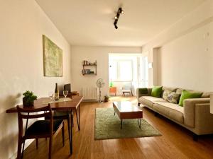 a living room with a couch and a table at Peaceful & panoramic views apartment, Cascais in Cascais