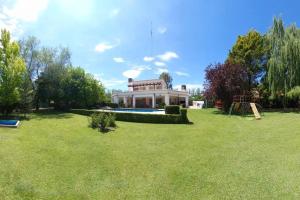 a house in a field with a large yard at Calma Vistalba in Ciudad Lujan de Cuyo