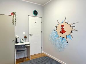 a room with a wall with a spiderman decal on it at MMRent Spidey Room in Gdańsk