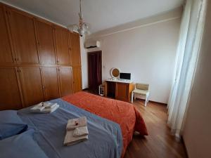 a bedroom with a bed with two towels on it at B&B Corallo in Sassari