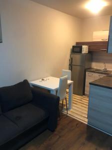 a living room with a couch and a table and a kitchen at apartment DIAMOND SARAFOVO in Burgas