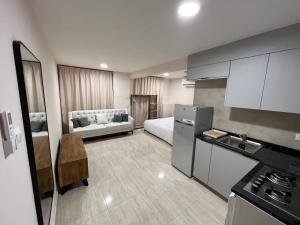 a room with a kitchen and a living room at Touch Residence in Al Ḩamīdīyah