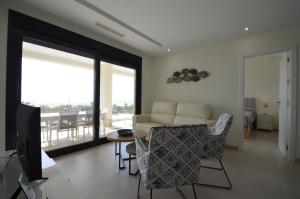 a living room with a couch and a table at Ocean Home EXCELLENT & SOLMARES in Isla Canela