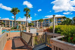 a resort with a pool and palm trees at High Pointe 231 in Rosemary Beach
