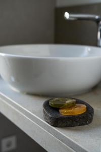 a rock on a counter next to a white bowl at Ferien.Wohnung.Sartoris in Bad Neuenahr-Ahrweiler