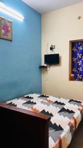 a bedroom with a bed in a room with at OYO 81239 Shri Vinayaka Inn Rooms in Tiruchchirāppalli