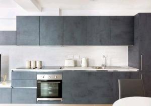 倫敦的住宿－Premier Central London North Apartment，厨房配有灰色橱柜、水槽和烤箱