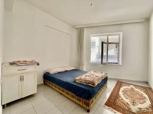 a small bedroom with a bed and a window at *Downtown* Furnished Flat [Mounthly Discount] D3 in Antalya