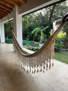 a hammock in a house with a large window at Habitación Juvenil Los Cerros in Paraguarí
