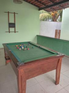 a pool table with balls on top of it at Pousada das Acacias in Carananduba
