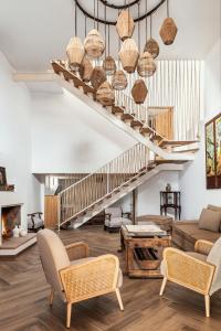 a living room with a staircase with wicker baskets at Apartamentos turísticos EL PATIO DEL NOGAL in Guadalupe