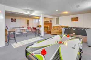 a room with a ping pong table and a living room at Hocking Hills Hideaway with Hot Tub and Fire Pit! in Logan