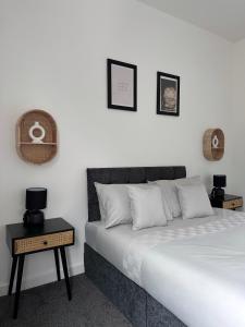 a bedroom with a bed and a nightstand next to it at Cosy Home in Manchester in Manchester