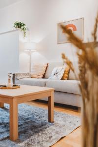 a living room with a couch and a coffee table at Scandic Primo Apartments - Malminkatu 49m2 in Helsinki