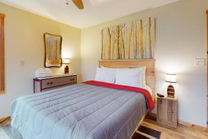 a bedroom with a large bed and a mirror at A Finger Lakes Favorite in Prattsburg