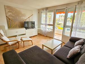 a living room with a couch and a tv at Laguna Beach Costasol - Alojamientos La Torre in Torrox Costa