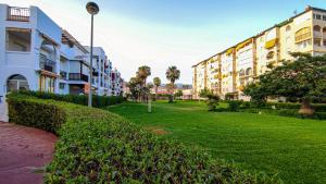 a row of apartment buildings next to a green park at Laguna Beach Costasol - Alojamientos La Torre in Torrox Costa