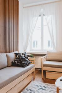 a living room with a couch and a window at Scandic Primo Apartments - Eerikinkatu 46m2 in Helsinki