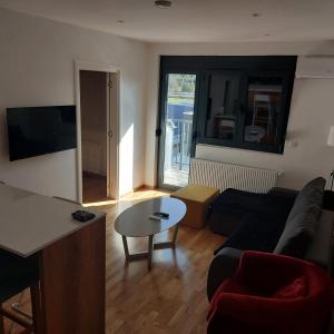 a living room with a couch and a table at Centar Crnjanski in Jagodina