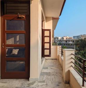 a door on the side of a building with a balcony at Zel’s Stay by Six Lane in Sohāna