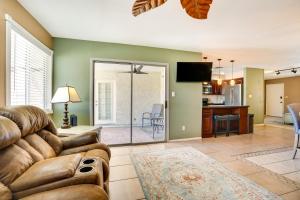 a living room with a couch and a dining room at Family-Friendly Peoria Retreat with Private Pool! in Peoria