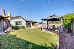 a backyard with a gazebo and a lawn at Family-Friendly Peoria Retreat with Private Pool! in Peoria
