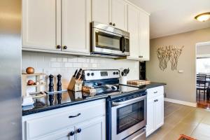 a kitchen with a stove and a microwave at Charming Portland Home, Walk to Light Rail! in Milwaukie
