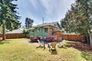 a yard with chairs and a table and a house at Charming Portland Home, Walk to Light Rail! in Milwaukie