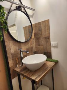 a bathroom with a white sink and a mirror at Le Volte B&B in Sammichele di Bari