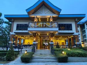 a building with a balcony with lights on it at Elegant, and Family-Friendly 2BR in Pine Suites in Tagaytay