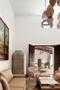 a living room with a couch and a table at Apartamentos turísticos EL PATIO DEL NOGAL in Guadalupe