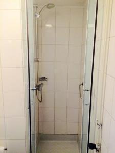 a shower with a glass door in a bathroom at Herberg de Geulhemermolen in Berg en Terblijt