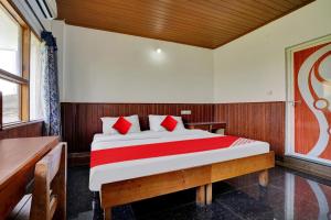 a bedroom with a bed with red pillows at OYO Flagship 81283 Plaza Residency in Cochin