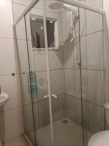 a shower with a glass door in a bathroom at Hollydayhouse in Prudentópolis