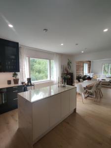 a kitchen with a white island in a living room at Unique villa by the lake in Lahti