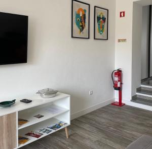 a living room with a tv and a white cabinet at d Albuquerque - AL in Ponte de Sor