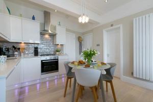 a kitchen with a table and chairs in a room at Sea Salt sea views parking in St Ives